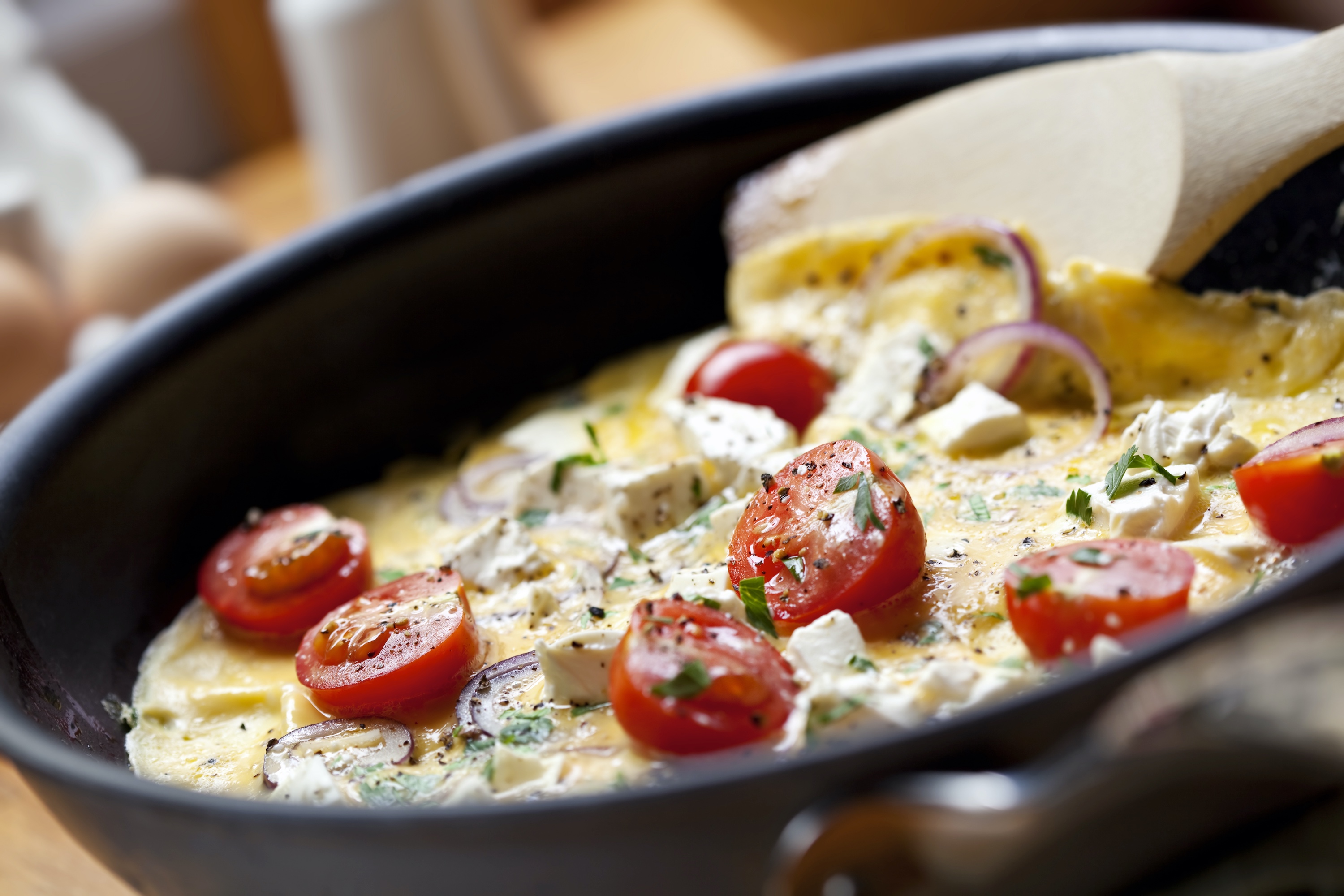 Stuffed omelet with feta and graviera cheese, turkey and tomato