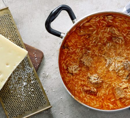 Meat soup with orzo and graviera cheese
