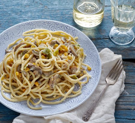 Vegetarian pasta with white sauce, mushrooms and peppers